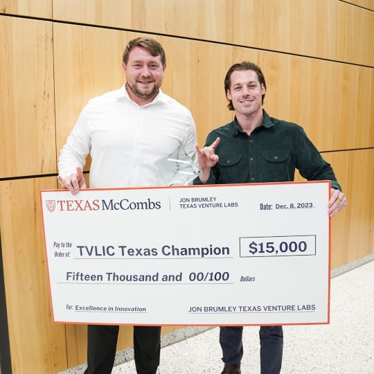 Tano Pharmaceuticals founders Sean Finney and Branson Berger hold the big check presented to them for being named Texas Champions at the Fall 2023 Texas Venture Labs Investment Competition.