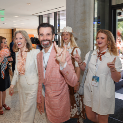 Harkey donors smiling at camera and giving Hook 'Em Horns