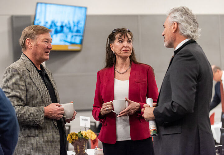 Two event attendees network over coffee