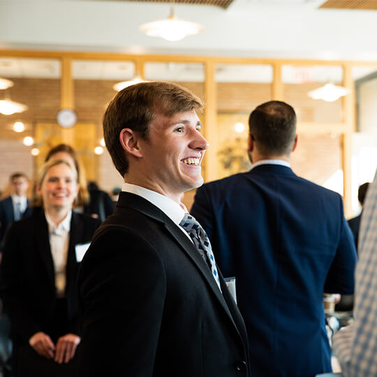 Event attendee smiles in business casual attire