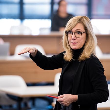 Faculty member gestures while teaching