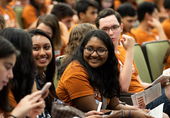 Students laugh in lecture hall at Gone to Texas event