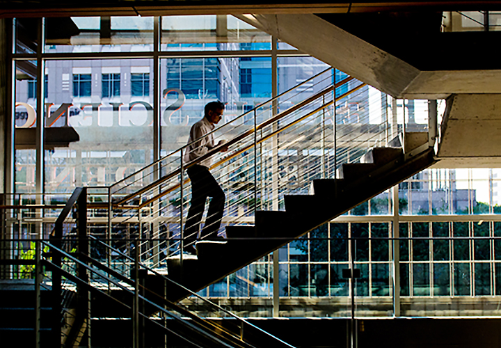 MBA student ascends the stairs in Houston