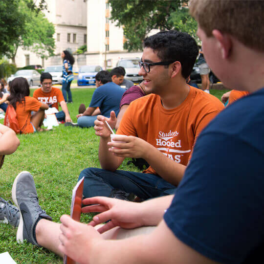 Students sitting in a circle on lawn