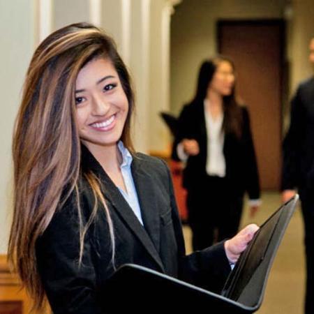 Smiling student hold open folder